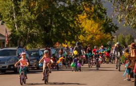 Salida Bike Fest event with dozens of adults and children riding bikes on the road