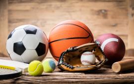 Pile of sport balls including soccer ball, tennis ball, basketball, football, baseball and mit