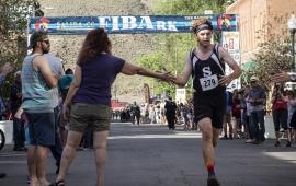 Runner crossing the finish line at a FIBArk race