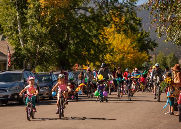 Salida Bike Fest event with dozens of adults and children riding bikes on the road